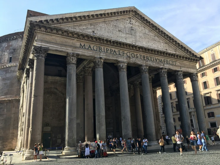 a crowd of people standing outside of a building