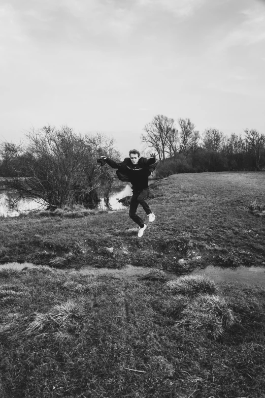 a boy playing with a frisbee in a field