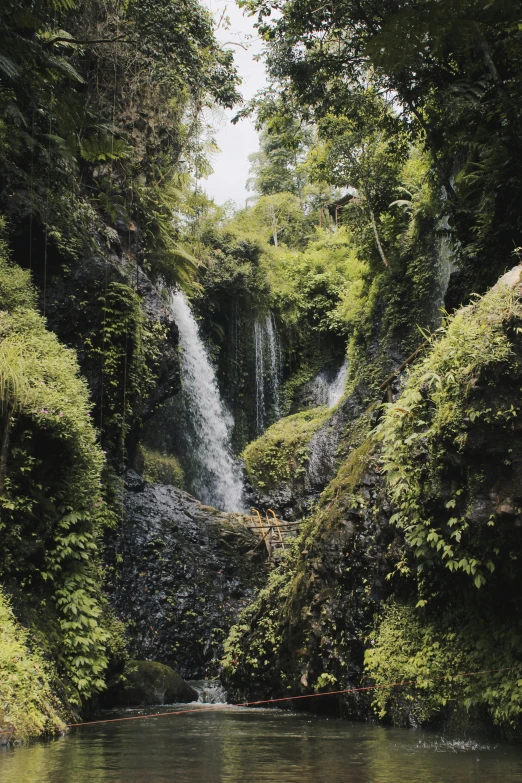 a large waterfall that is sitting over some water