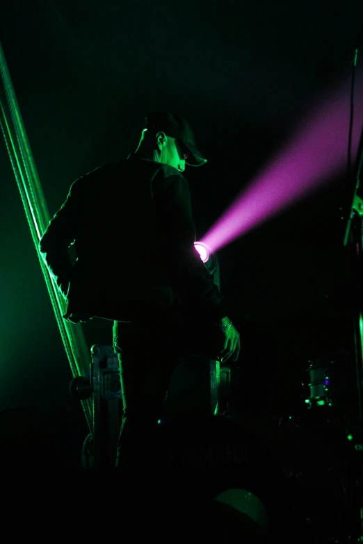 a male with a hat and shirt on on stage