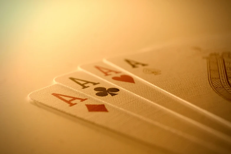 three ace playing cards sitting on top of each other
