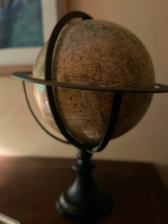 a small old fashioned globe is on a stand