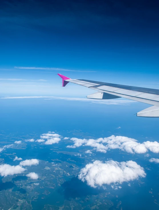 the wing of an airplane flying over a lot of clouds