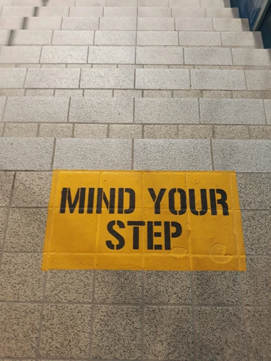 a yellow sign on the side of a building