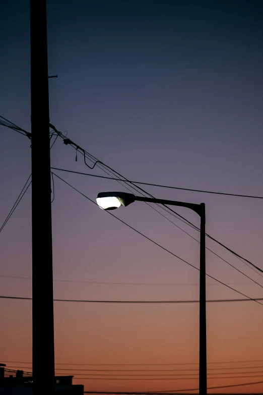 telephone wires are in the foreground at sunset