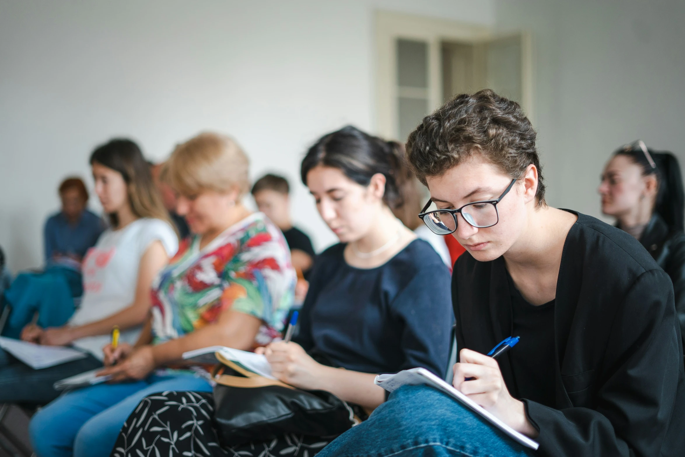 students are sitting on the floor while doing work