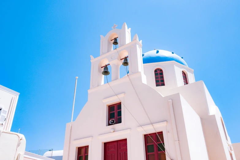 a white building with a church bell tower in the back