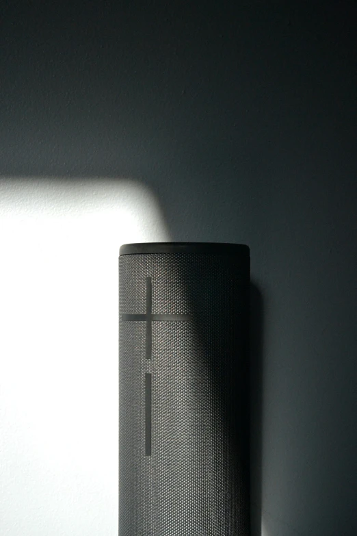 the back end of a speaker stands in a dim light