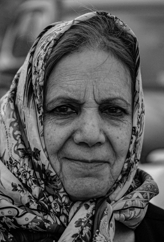 a black and white portrait of a smiling woman