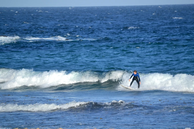 surfer standing in the middle of a wave