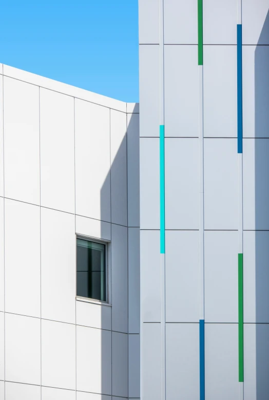 there is a building that has green and blue horizontal bars on it