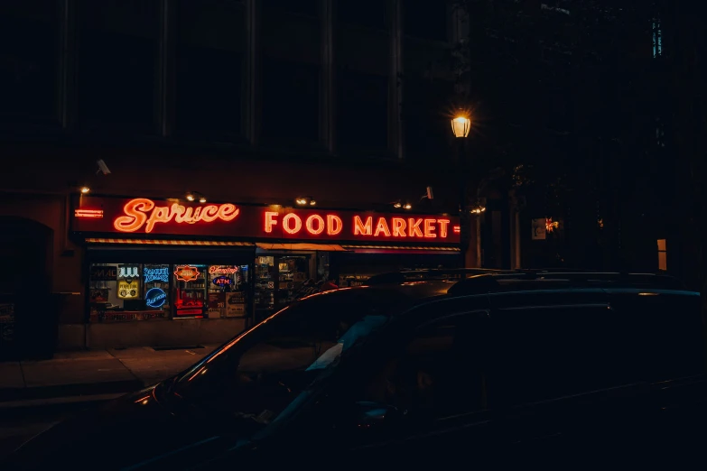 the building is lit up at night with red lights