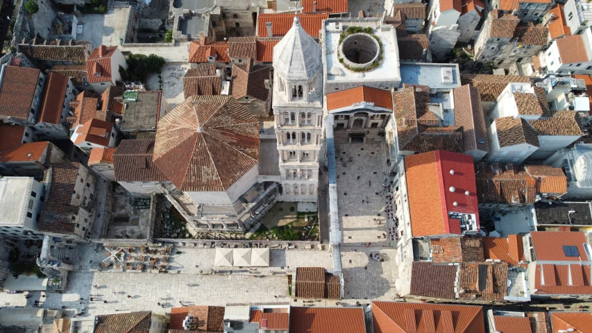 view of buildings with orange roofs and a green dome in the center