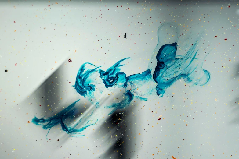 an art work in which the colors of the liquid are white, blue and gold