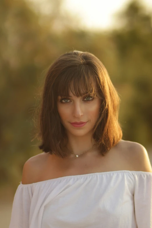 young woman in white blouse standing outdoors