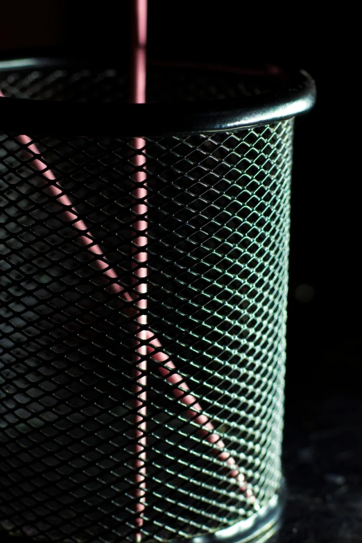 a wire mesh basket with two different shades of light