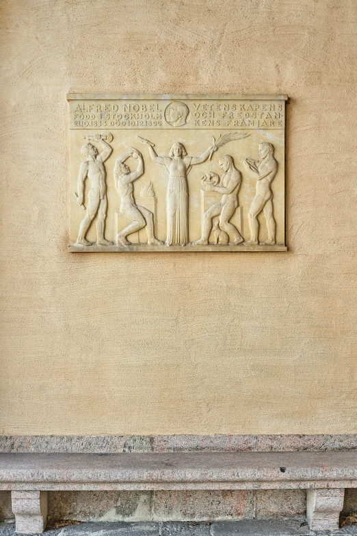 an architectural carving on a wall near a fire hydrant