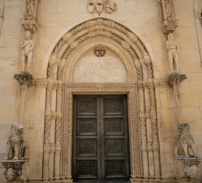 a doorway of a building with statues in front of it