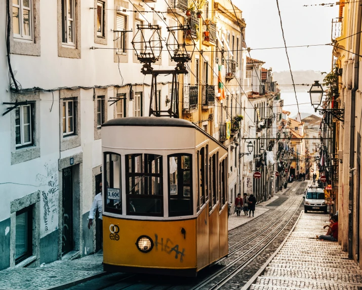 an old tram going down a street next to buildings