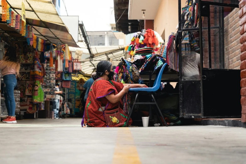 a woman in an indian outfit sits down reading a book