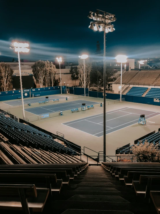 a tennis court that is empty with chairs