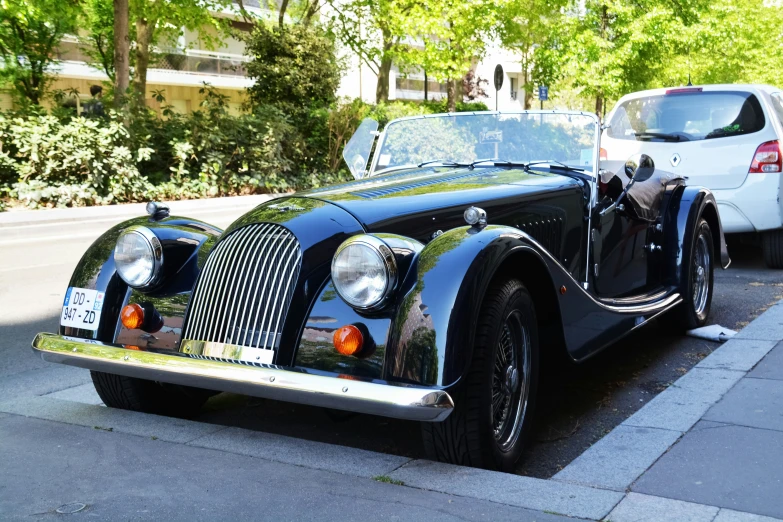 vintage car parked near curb with cars behind it