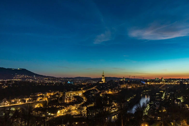 a beautiful city skyline at night with blue sky