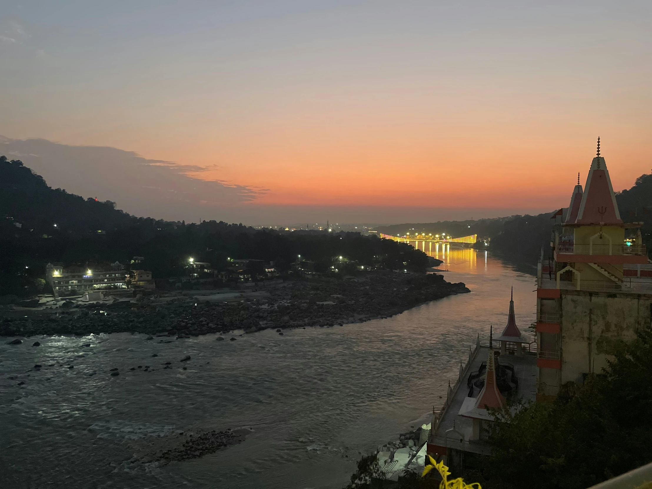 view of a river and cathedral with buildings at dusk