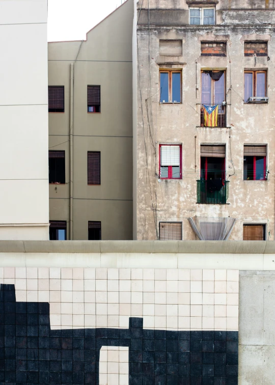 an apartment building with a brick facade, shuttered windows and a motorcycle parked in front of it