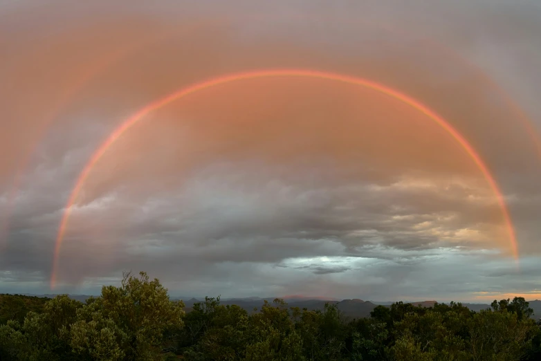 two rainbow arches on an overcast cloudy sky