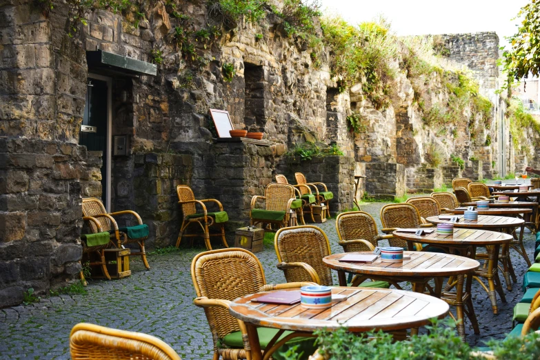 outdoor dining set up outside in front of an old stone building