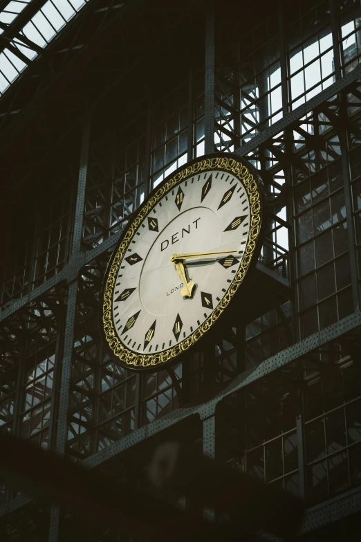 a clock on the side of a wall in front of windows