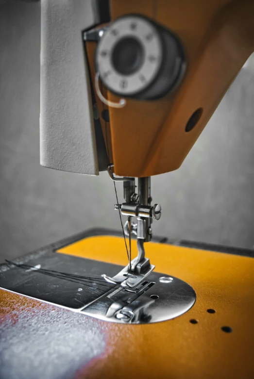 a sewing machine stitches fabric into fabric