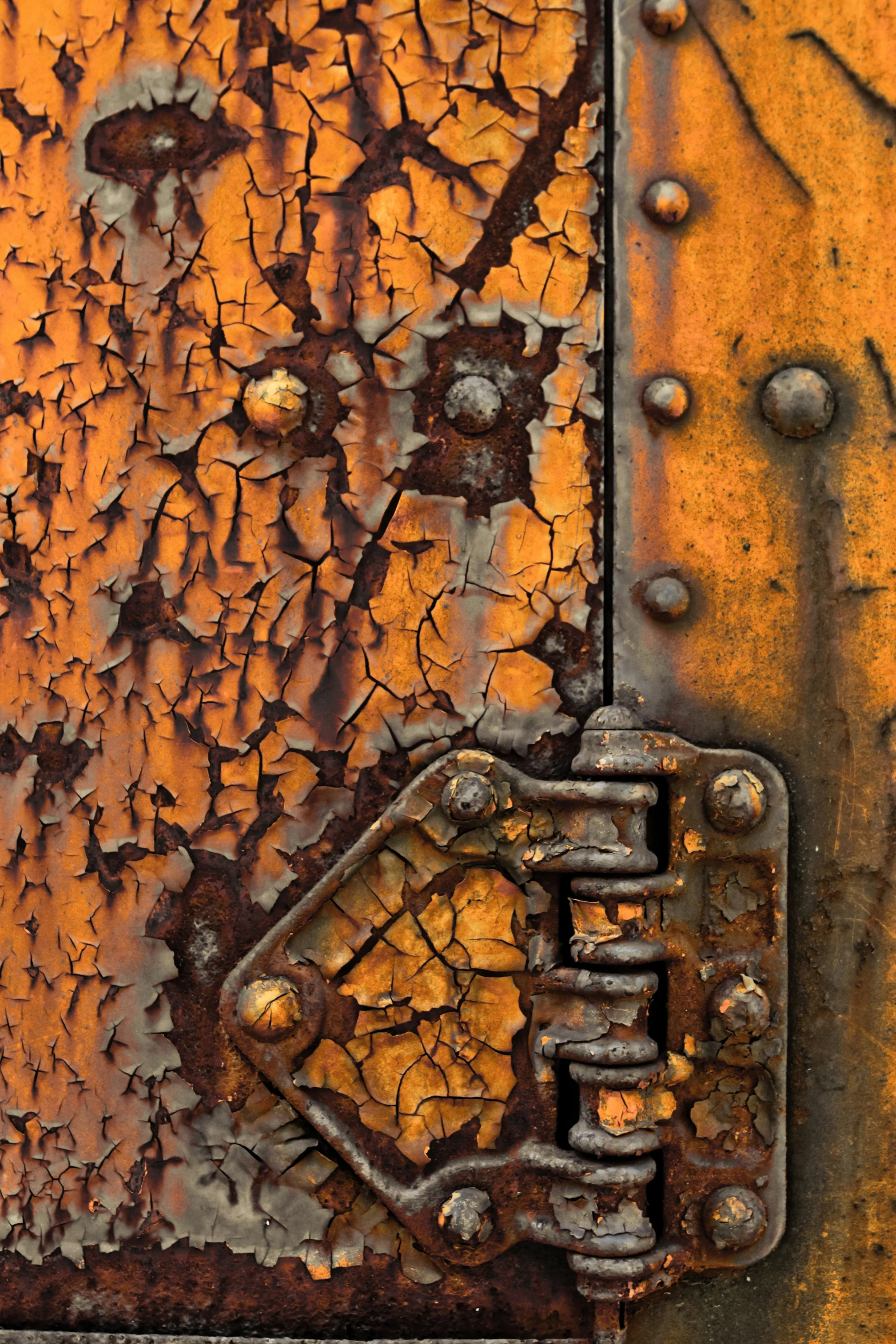 an orange rusted surface that is peeling and rusting