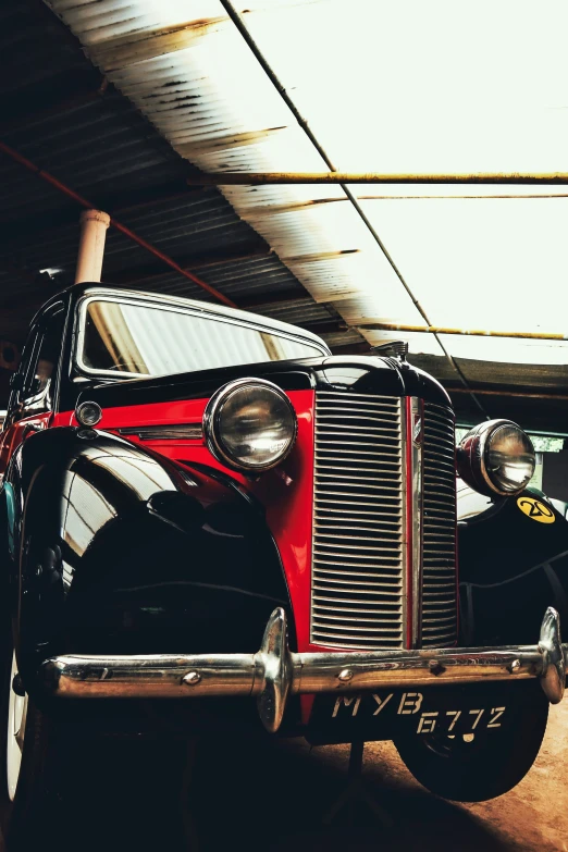 an old classic car is parked next to a building