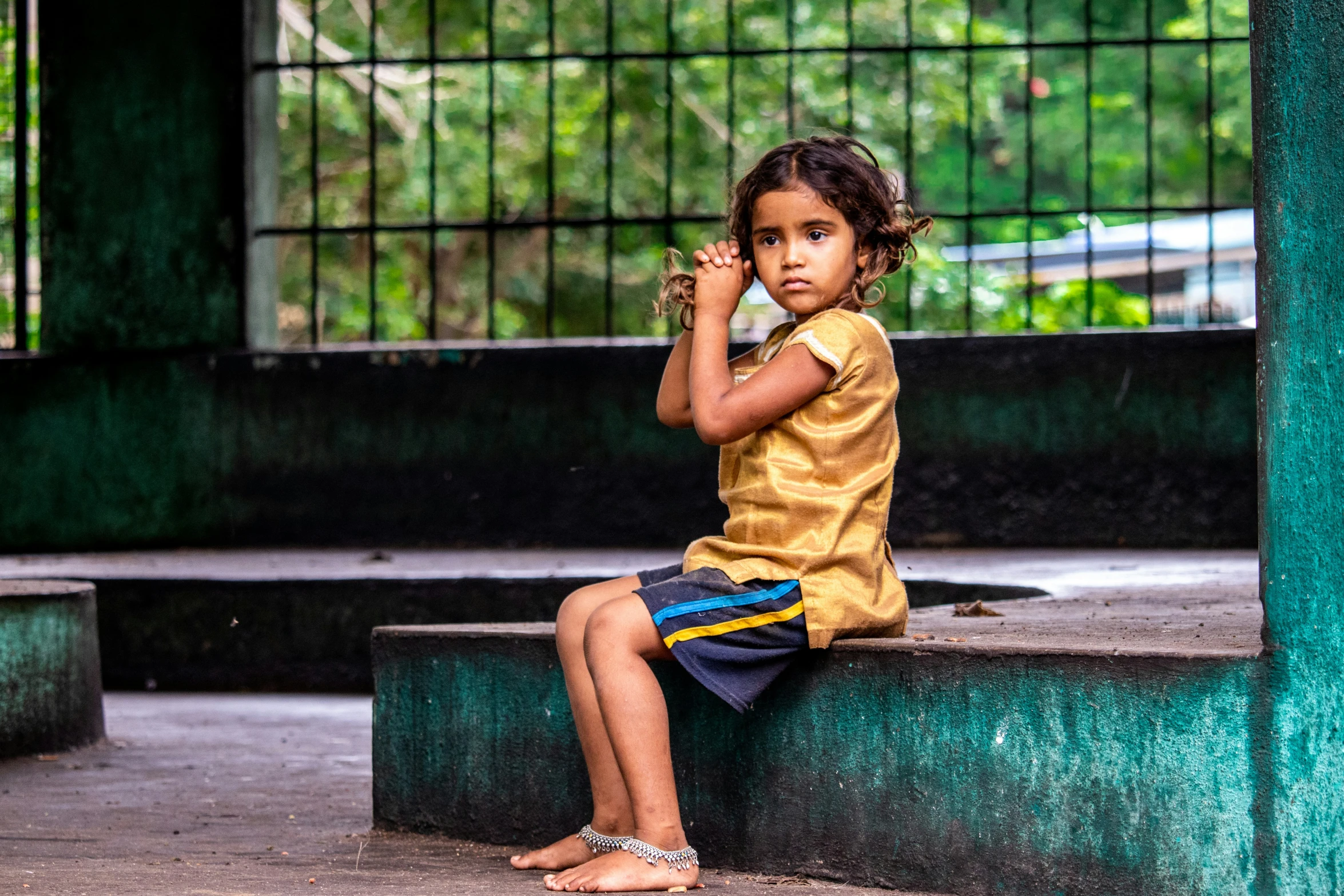 a  sitting on steps talking on her cell phone