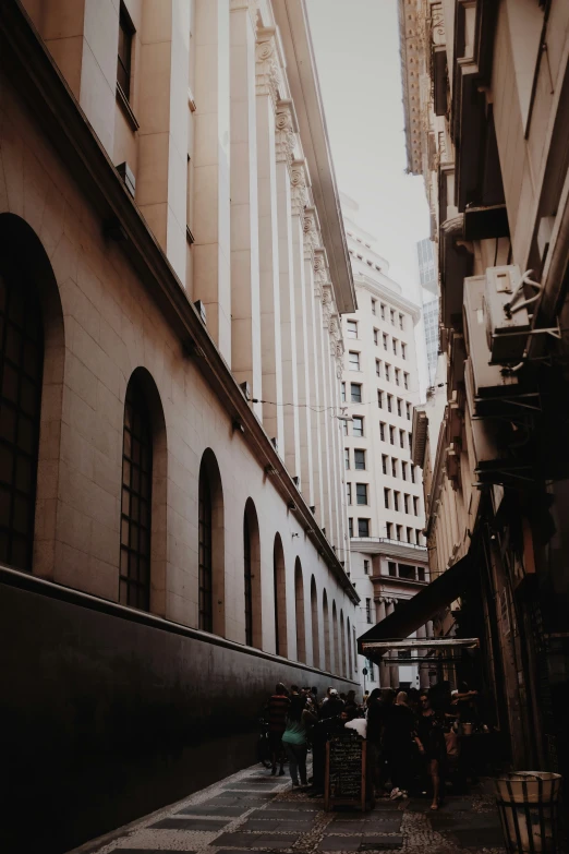 the view down the alleyway shows tall buildings