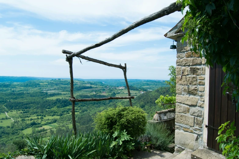 a balcony overlooking a valley, forest and rolling hills