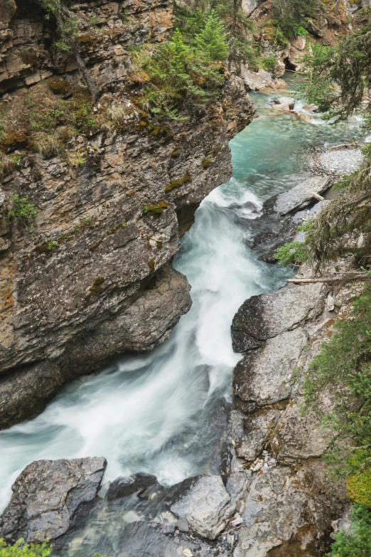 flowing water is flowing along the rocks in this view