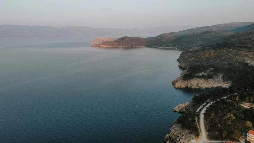 aerial view of water with trees and mountain