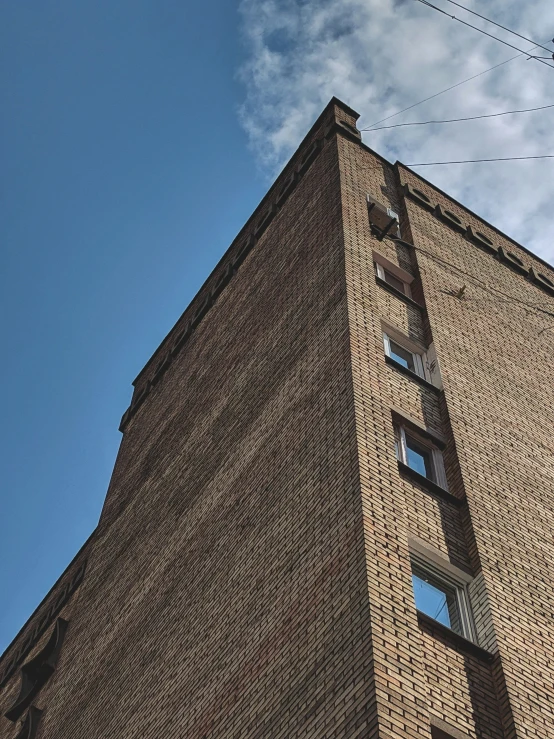 a tall building made of brick against a blue sky