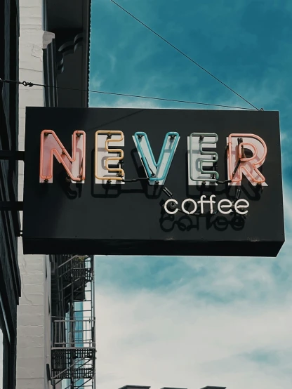 neon sign on the corner of a coffee shop