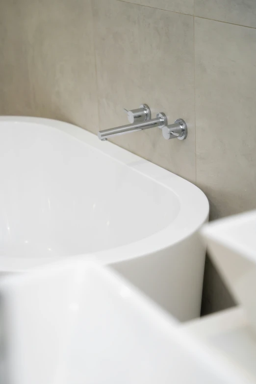 a round white tub sitting next to a white sink