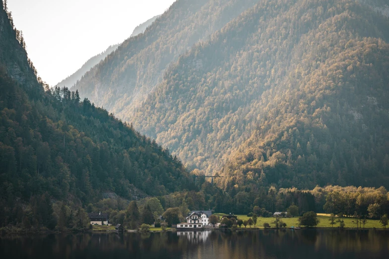 a lake in the middle of a green mountain range