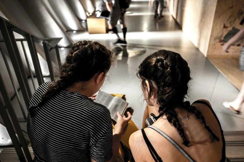 two women stand next to each other in a lobby