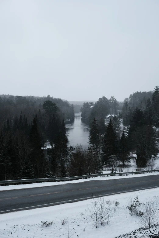 a car on a snowy road with trees behind it