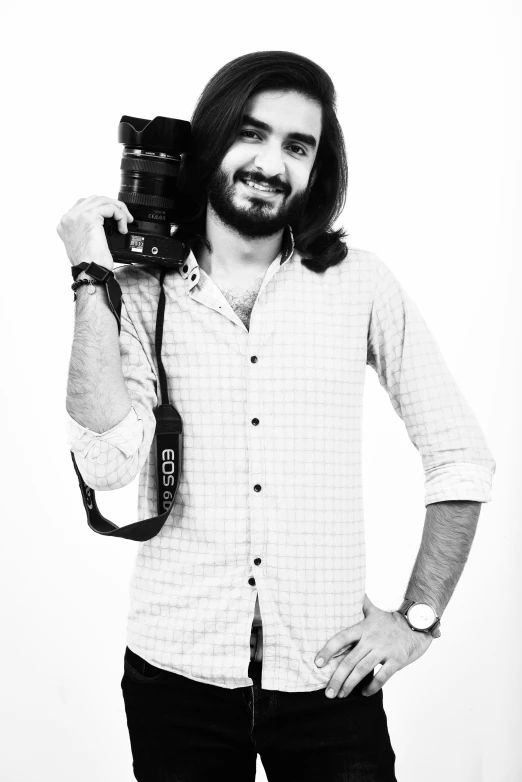 a man holding his camera on a strap around his shoulder