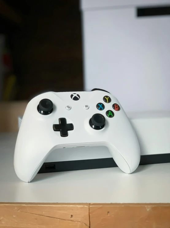 a closeup of a white controller and display