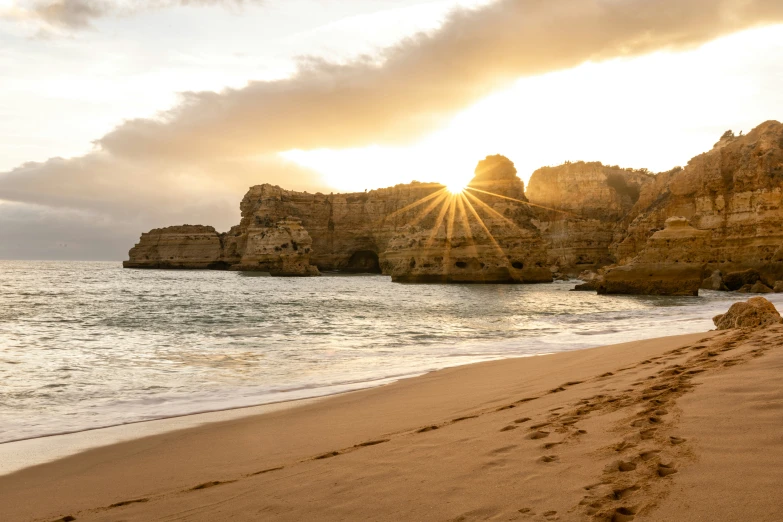 an image of a sandy beach with footprints in the sand