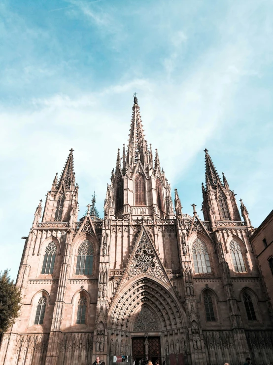 a very large cathedral sits against the blue sky